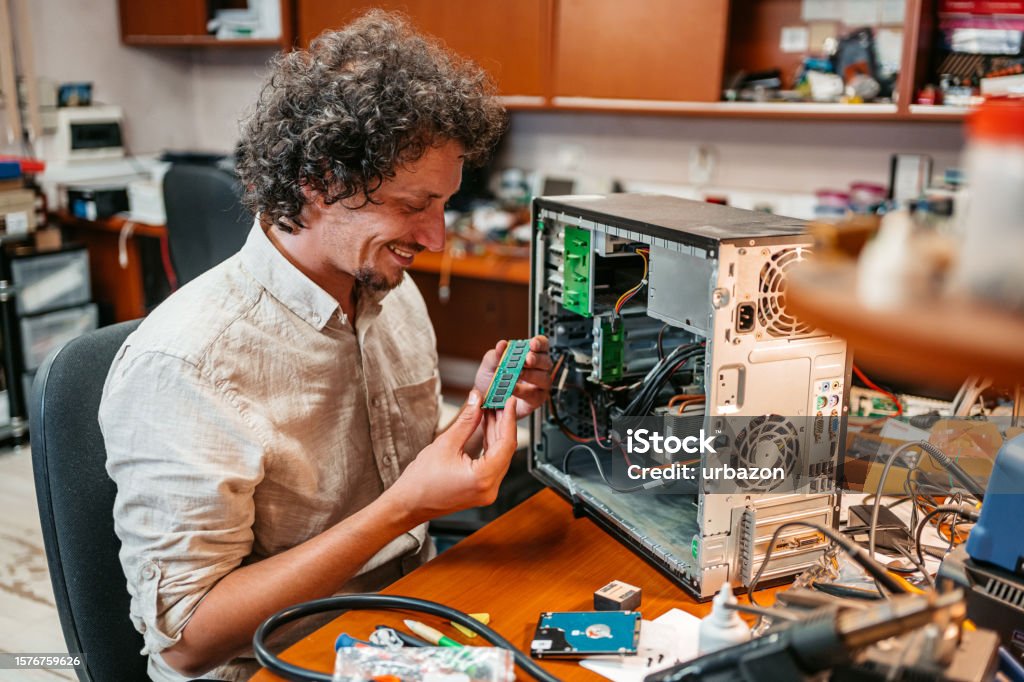 Young Man Checking Ram Component In A Workshop Stock Photo - Download ...