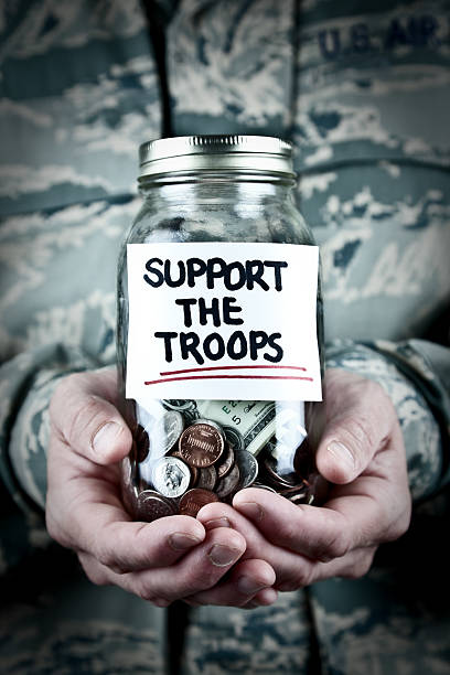 istock US Soldier Holding Donation Jar 157676010
