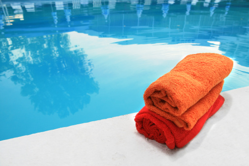 Two colored towels near the pool