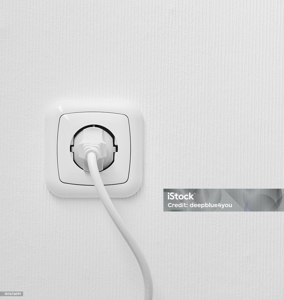 brand new outlet on a white wall with plug brand new outlet on a white wall with plug and copyspace Electrical Outlet Stock Photo