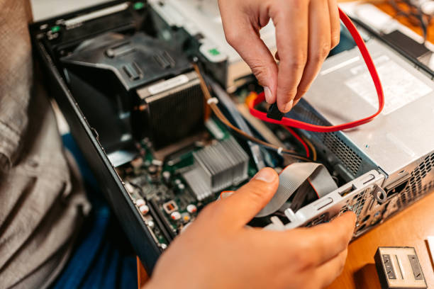 istock Technician Connecting Cable Reaching Into The Interior Of A Computer Unit 1576761151