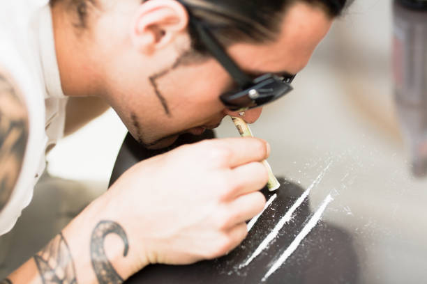 Drug Abuse Young man doing Cocaine  snorting stock pictures, royalty-free photos & images