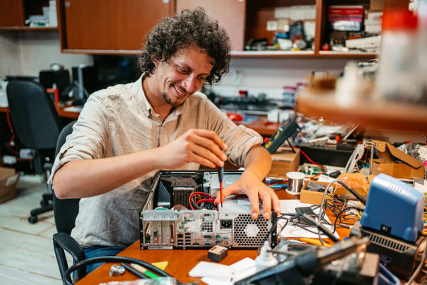 istock Young Man With A Screwdriver Repairing Desktop Computer 1576761669