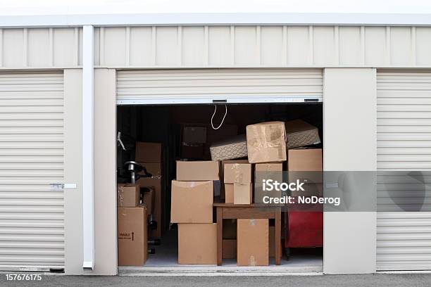 Self Storage Warehouse Building With An Open Unit Stock Photo - Download Image Now - Storage Compartment, Self Storage, Storage Room