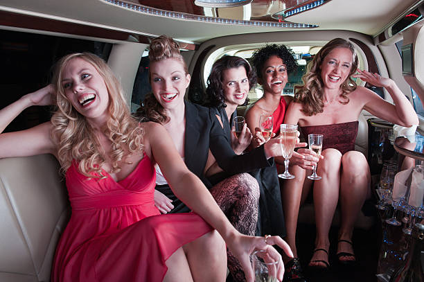 istock Group of girls with drinks sit in a limo 157676728