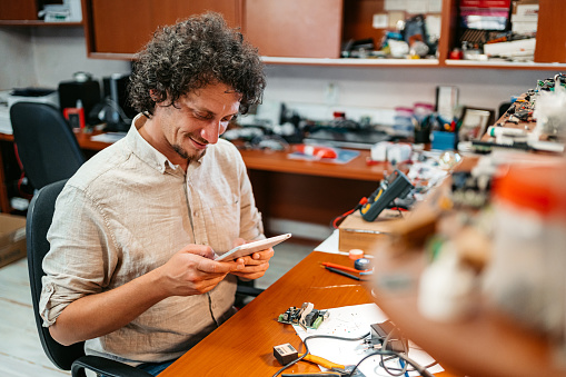 Man Watching A Tutorial About Computer Electronics Using Digital Tablet ...