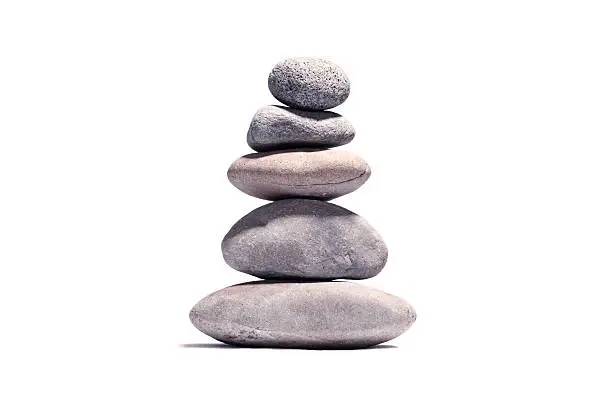 Photo of Stack of volcanic pebbles isotaded on white with clipping path