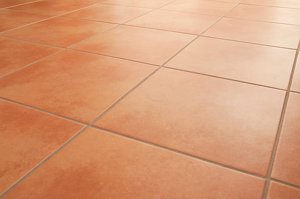 Terracotta floor tiles clean background diminishing perspective Shiny and neat italian style ceramic floor tiles, diagonal, selective focus. terracotta stock pictures, royalty-free photos & images