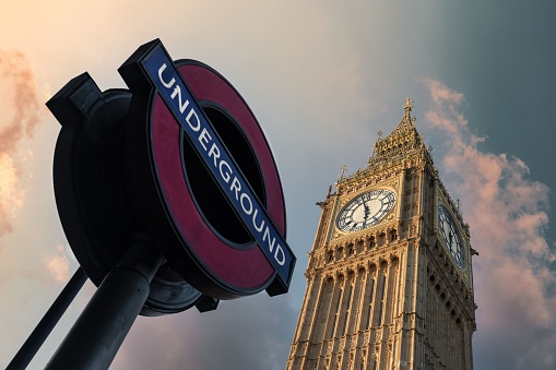 London, United Kingdom – February 16, 2022: An image of the iconic Big Ben clock tower in London, England, situated against the backdrop of an underground metro sign