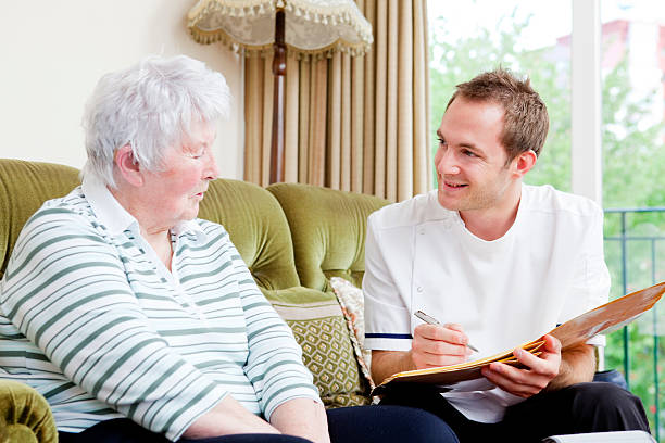 istock Nurse and senior patient chatting during in-home care 157677265