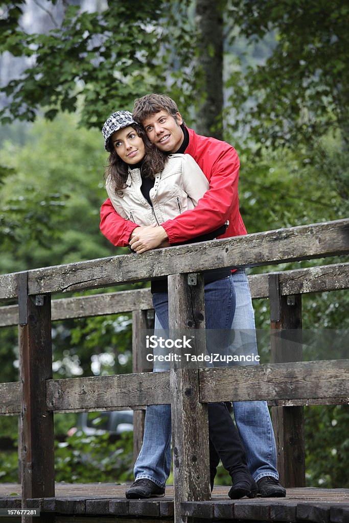 Young couple on a bridge Young couple daydreaming on a wooden bridge. Image was shot on the Minilypse Bad Aussee. Adult Stock Photo