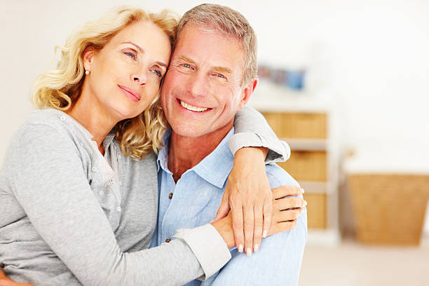 istock An attractive couple embracing each other at home 157677311