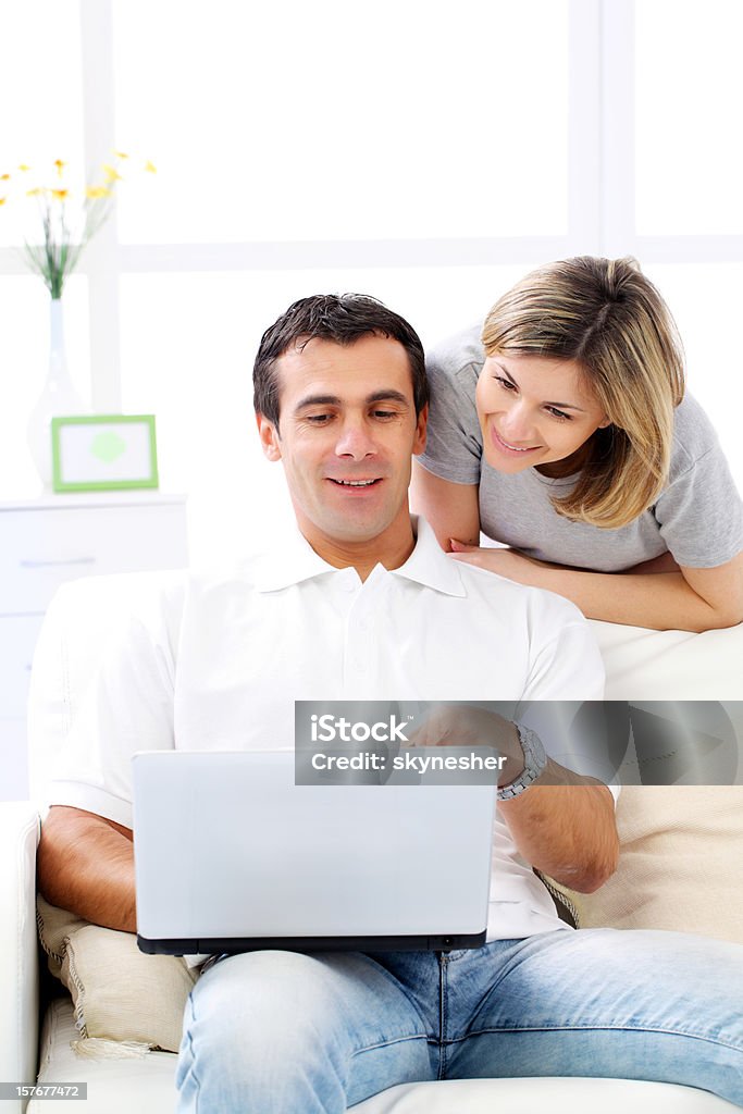 Casal jovem, usando um laptop em casa. - Foto de stock de Adulto royalty-free