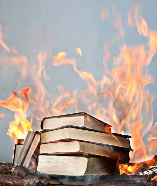 Photo of short stack of books ablaze