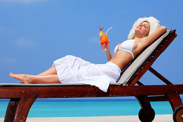 istock Lady relaxing in the chaise lounge on a exotic resort. 157677550