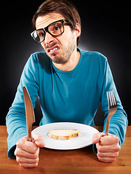 istock Student must tighten the belt, he is eating only bread 157677754