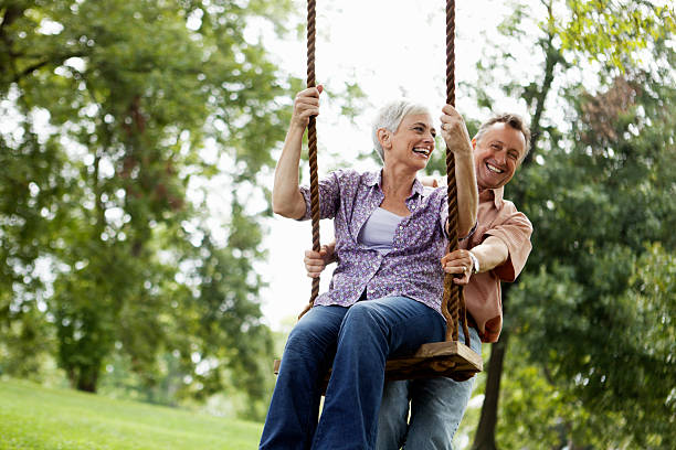 istock Senior Couple Playing on a Park Swing 157678025