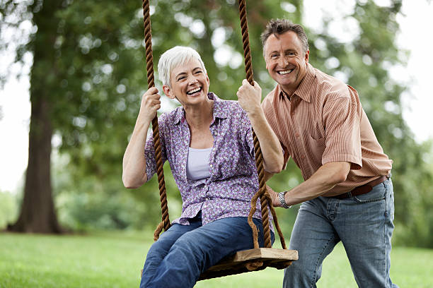 istock Senior Man Pushing his Wife on a Swing 157678042