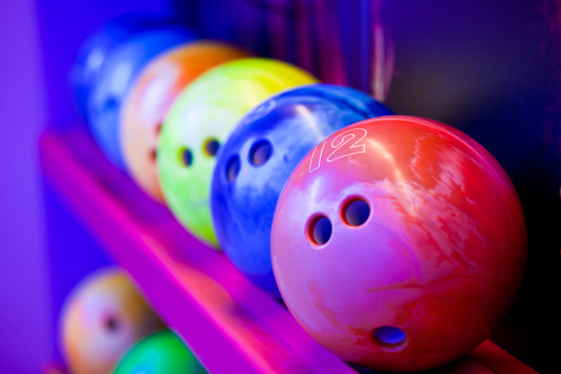 Bowling balls on ball shelves. Cosmic bowling colors.