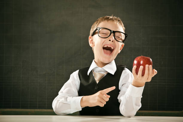 istock beautiful toothless school student kid with blackboard and apple 157678197