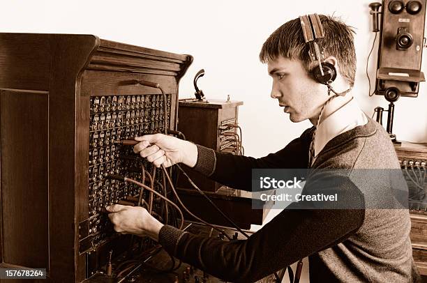 Telephone Operator Using Antique Switchboard Stock Photo - Download Image Now - Old-fashioned, Switchboard Operator, Telephone Switchboard