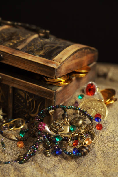 Wooden chest with treasures isolated on white