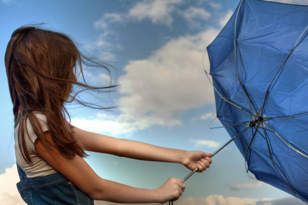 istock Young girl holding an umbrella that is inside out 157678450
