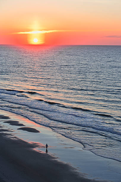 istock Solitary walker with ocean sunrise or sunset 157678493