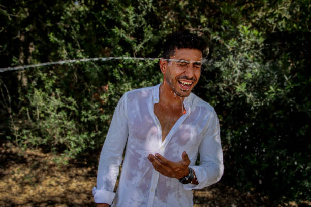 istock Young man wet at the park 1576786964