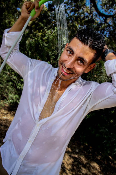 istock Young man wet at the park 1576787062