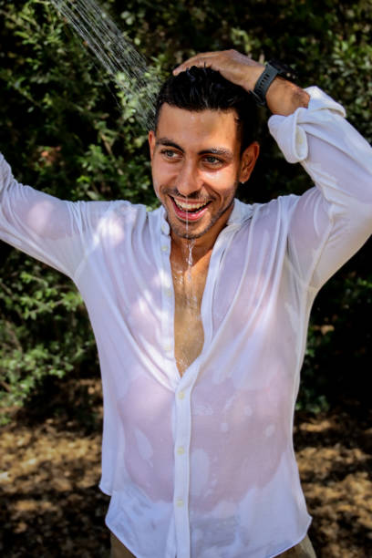 istock Young man wet at the park 1576787064