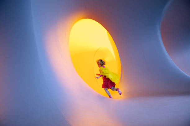 Baby boy playing in a tunnel tube