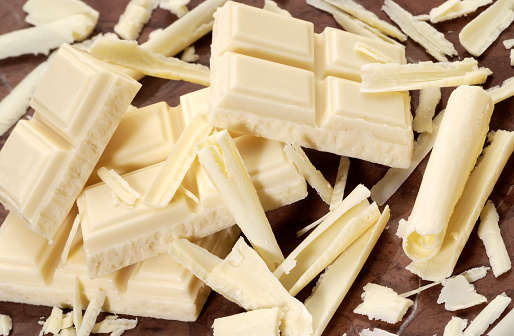 Bars,curls and fragments of white chocolate.