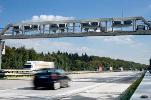 German highway - control gantry/bridge with passing cars and trucks