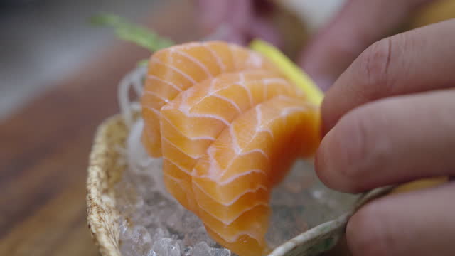 Salmon being put onto serving plate