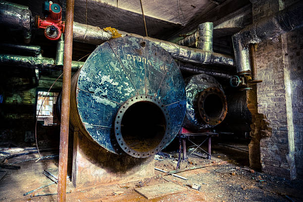 Abandoned Industrial Building Basement With Tanks and Tubes Abandoned Industrial Building With Tanks and Tubes. HDR Image, strong grainy, toned. Location: Beelitz, East Germany. beelitz stock pictures, royalty-free photos & images