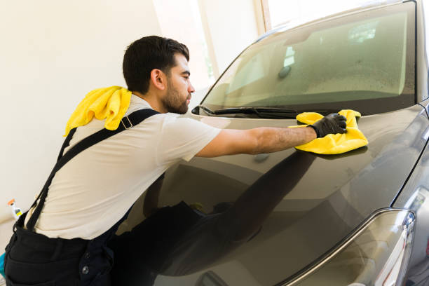 istock Hispanic employee washing a customer's car 1576799177