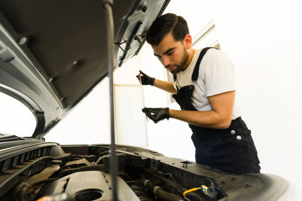 istock Mechanic checking engine oil level of a car 1576801668