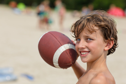 Young boy throwing football
