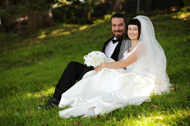 istock Bride and Groom Sitting in a Garden 157680246