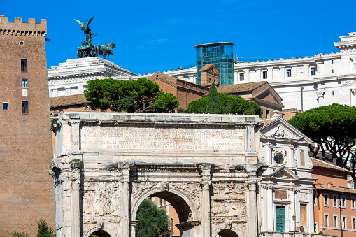 Rome, Italy - October 8, 2020: Ancient Romun Forum with Arch of Septimius Severus. Victor Emmanuel II Monument in a distance