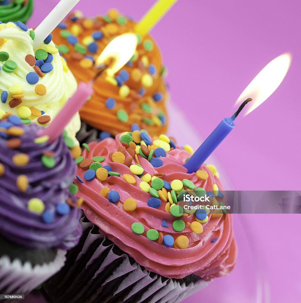 Colorful Birthday Cupcakes Birthday cupcakes with burning candles.  Birthday Stock Photo
