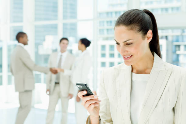 istock Beautiful Businesswoman using a Cellphone in an Office Lobby 157680467