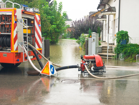 Fire engine pumping water from flooded house. Slovenia.