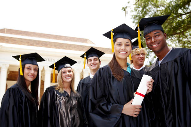 istock Group of multiracial students in cap and gown with diploma 157680891