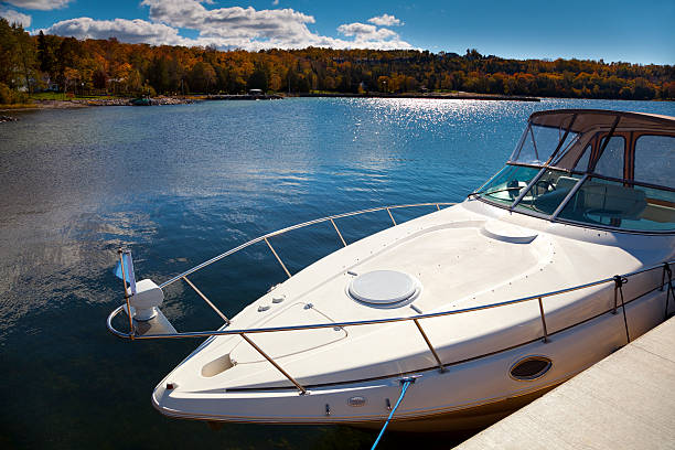 Luxury Boat Moored in Sunny Autumn Harbor Luxury Boat Moored in Sunny Autumn Harbor boat on lake stock pictures, royalty-free photos & images