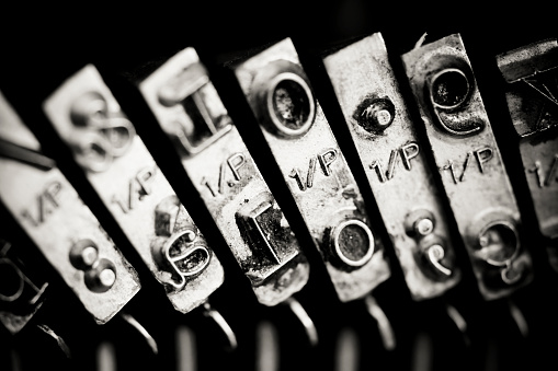 Black and white macro shot of typewriter heads.