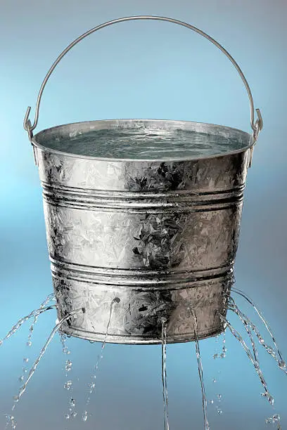 Photo of Bucket with holes leaking water