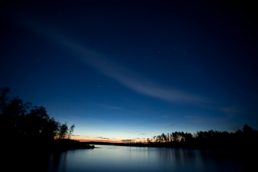 Sunset on the clear sky. Color gradient of the morning sky. Dusk sky with stars above horizon. Beautiful bright sunrise on the sky, background.