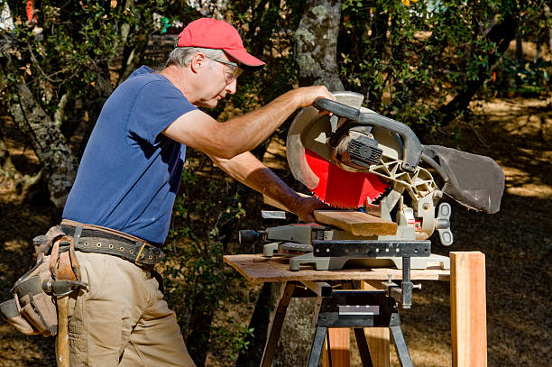 Carpenter and Compound Mitre Saw  miter saw stock pictures, royalty-free photos & images